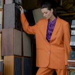 A Woman in Orange Blazer and Orange Pants